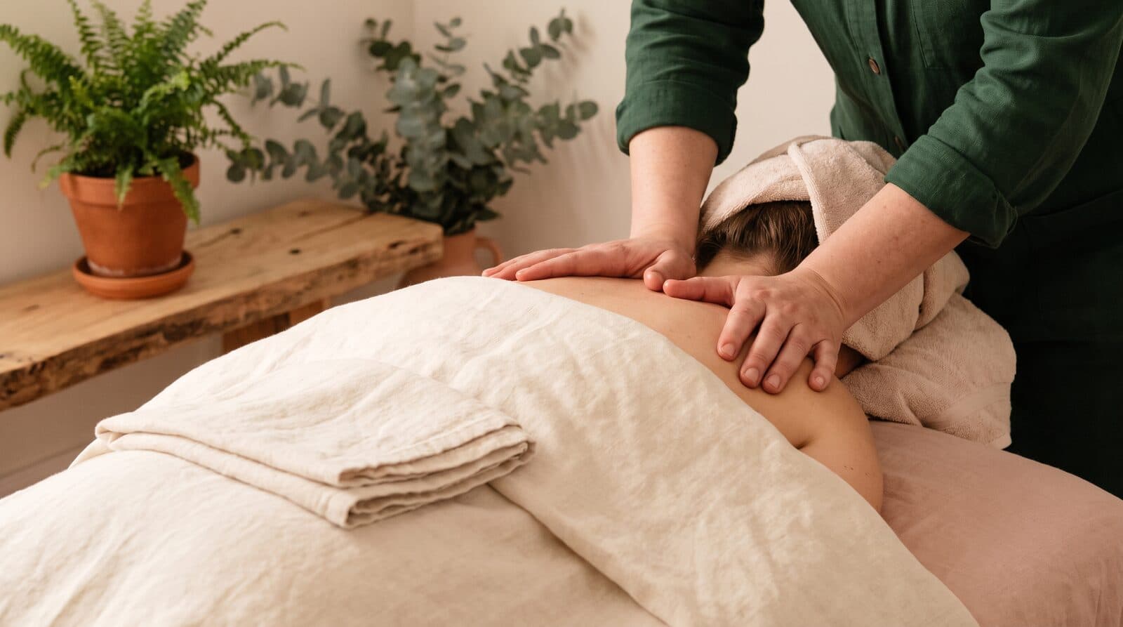 Fern & Soul neck and shoulder massage in Innaloo, a therapist's hands working across a relaxed client's upper shoulders.