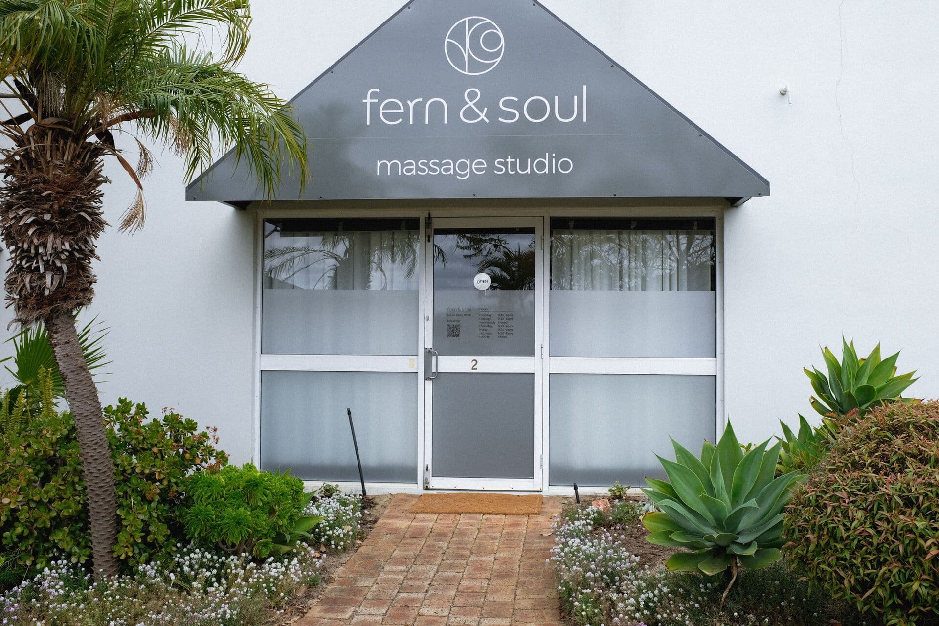 Fern & Soul massage studio shopfront in Innaloo, Perth, the grey gable sign above the glass door marked 2.