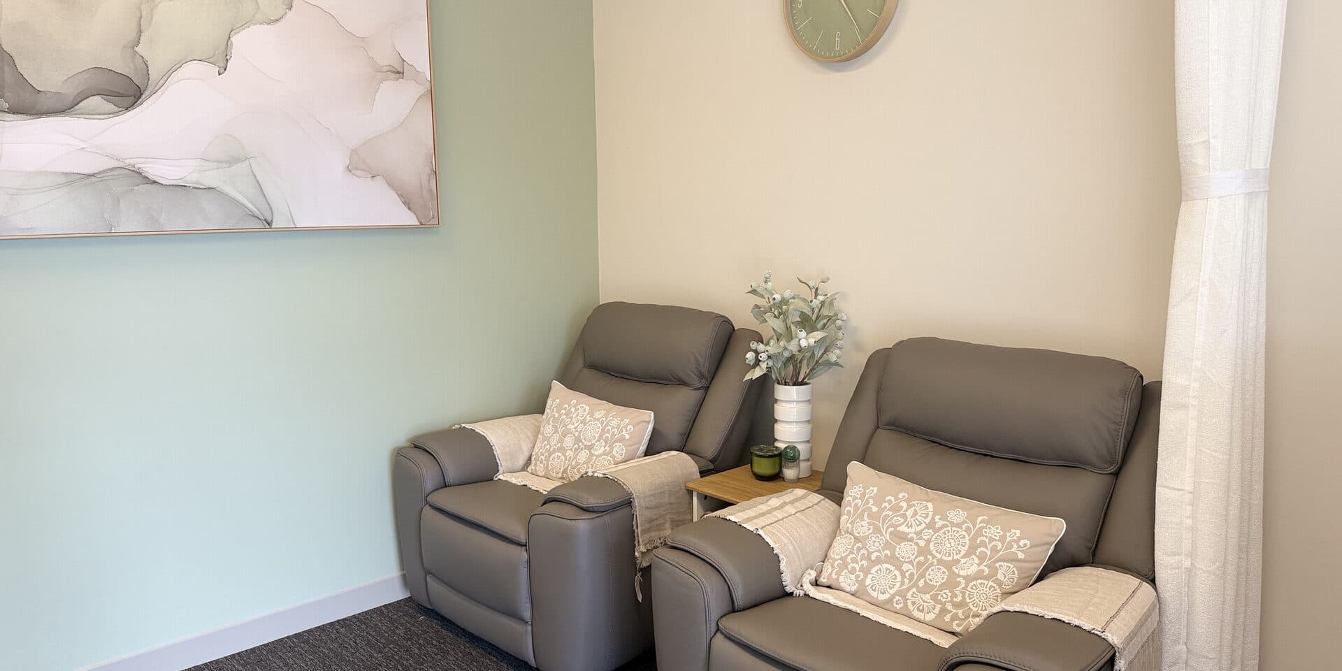 The waiting area at Fern & Soul massage studio Innaloo with recliner chairs, soft throws and calm neutral styling