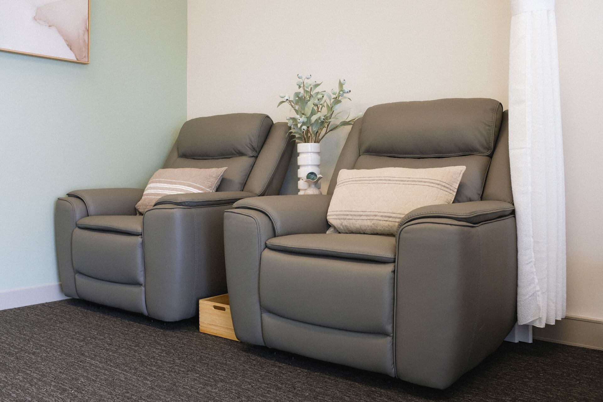 Two grey leather recliners in the waiting area at Fern & Soul massage studio in Innaloo.