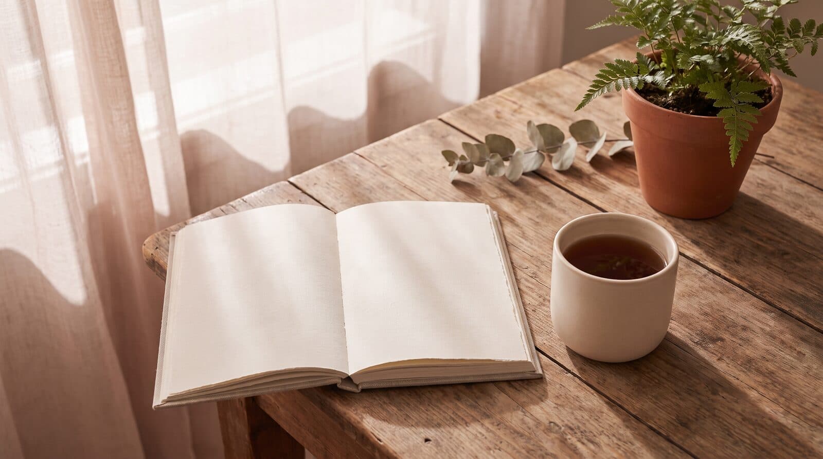 Fern & Soul massage routine planning in Innaloo, an open notebook and a mug of tea on a timber table beside a potted fern.